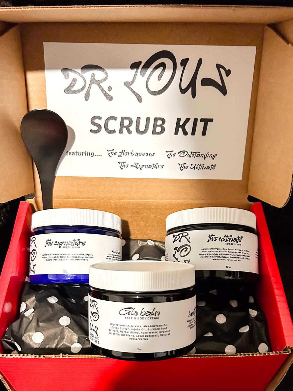 Dr. Lou's scrub kit with containers and a spoon in an open cardboard box.